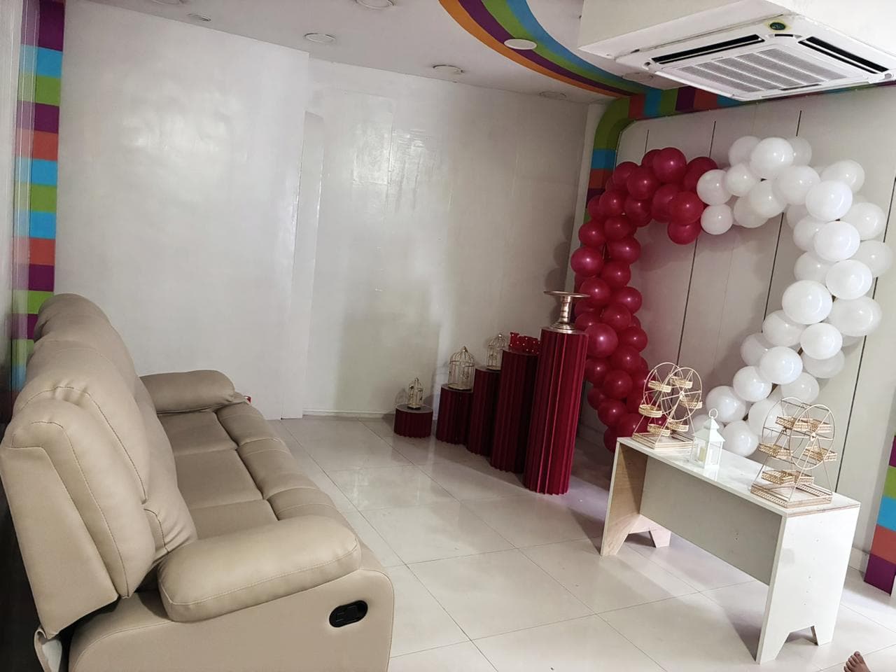 Romantic celebration corner with balloon decor and sofa